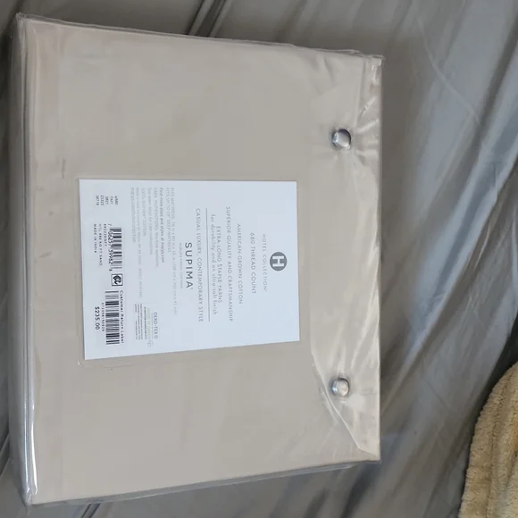 New in package hotel collection supima fitted sheet for king size bed. Tan